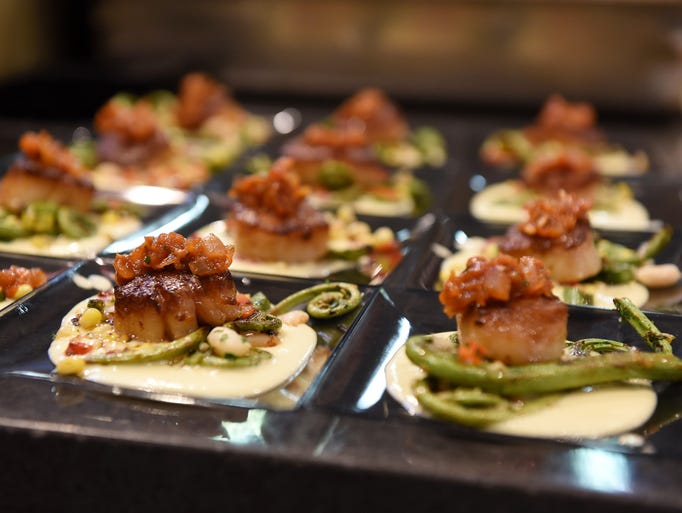 Sautéed scallops at the entree station prepared by