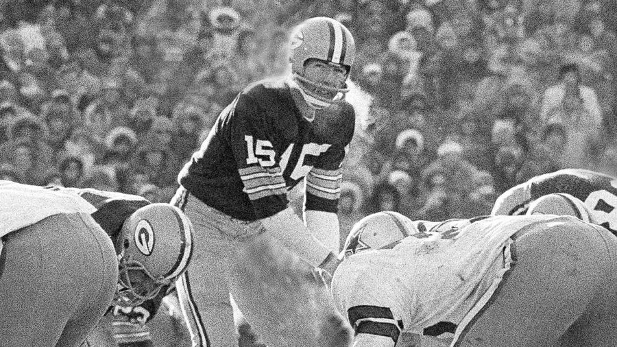 In this Dec. 31, 1967, file photo, Green Bay Packers quarterback Bart Starr calls signals in bitter cold as he led the Packers to a win over the Dallas Cowboys in Green Bay, Wisc. Fifty years later, players from the Packers and Cowboys still shiver from memories of the bitter cold of a game that would become known as the Ice Bowl.