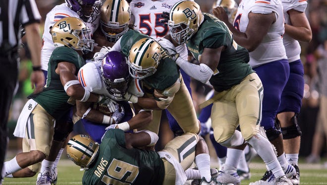 Northwestern State Demons running back Chris Jones (20) is gang tackled by the Baylor Bears defense during the second quarter at McLane Stadium.