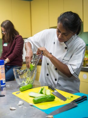 Chef Jes Thomas, right, grates cucumbers during a Taste of India cooking demonstration at the Central Collective in Knoxville on Sunday, Dec. 11, 2016. 