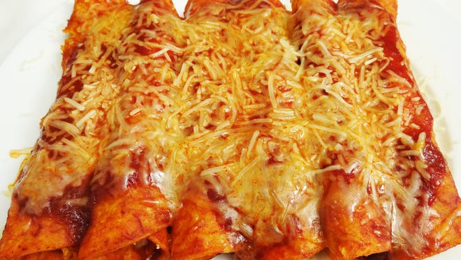 Red rolled cheese enchiladas.