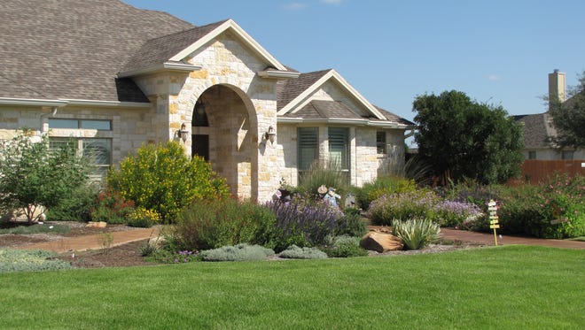 The front yard of Ron and Nancy Knight’s San Angelo home has a traditional style landscape that is drought tolerant and well-adapted to local conditions.