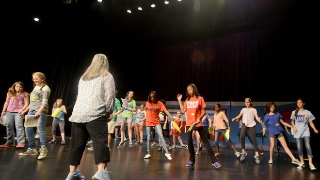 Diann Robinson teaches campers dance moves during their rehearsal Wednesday for the musical “Let’s Put on a Show” at The Ned R. McWherter Cultural Arts Center’s Performing Arts Camp.