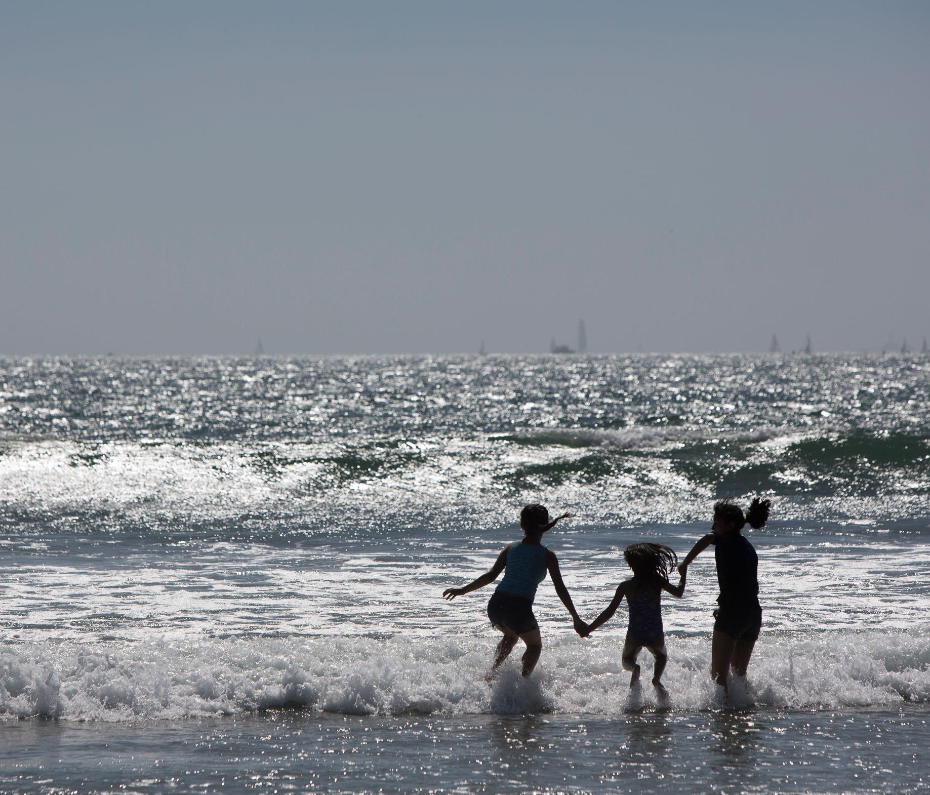 Beachgoers play in the break on Coronado Island in San Diego on April 2, 2017.