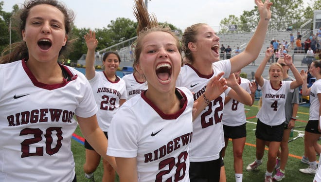 Maroon players (from left to right) Alex Absey, Riley Ricciardi Lillie Cloak celebrate after winning the Group 4 title in 2016.