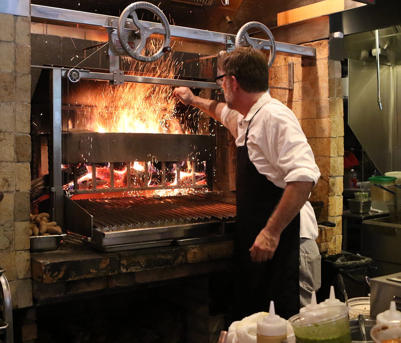 Executive chef Mark Jensen works the oven at Lexington, Ky.'s Middle Fork Kitchen Bar to create seasonal dishes from locally sourced ingredients like lamb sausages that are house-ground from 100% local lamb and served with fennel salad and house-made