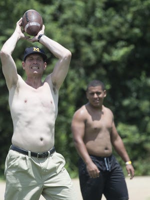 At the end of the camp, Harbaugh joined “team skins” and ran around shirtless with his trademark khakis.