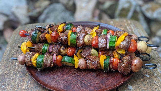 Steak kebabs are easy to grill over an open fire so long as you have a grate and a pair of gloves.