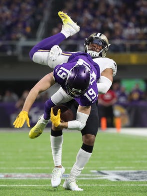 Vikings wide receiver Adam Thielen catches a pass against