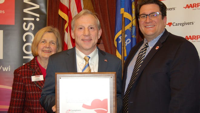 State Rep. Mike Rohrkaste (R-Neenah), center, was honored by AARP Wisconsin as a 2016 “Capitol Caregiver."  He is flanked by AARP Wisconsin’s State President Donna McDowell, left and State Director Sam Wilson.