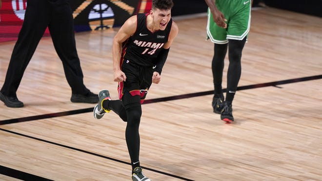 Miami Heat guard Tyler Herro (14) celebrates a basket against the Boston Celtics late in the second half of Game 4 of an NBA basketball Eastern Conference final, Wednesday, Sept. 23, 2020, in Lake Buena Vista, Fla.