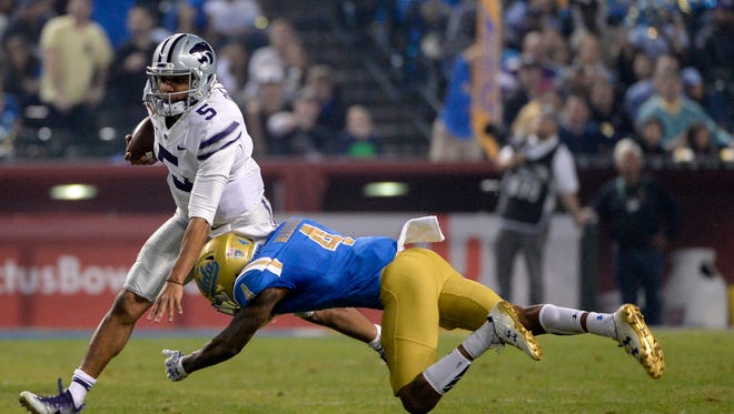 Kansas State Wildcats quarterback Alex Delton (5) is tackled by UCLA Bruins defensive back Jaleel Wadood (4) during the first half in the 2017 Cactus Bowl at Chase Field.