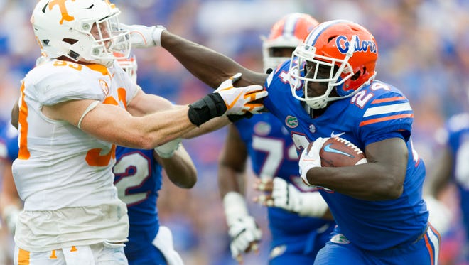 Florida running back Mark Thompson (24) pushes away Tennessee punter Trevor Daniel (93) during the Tennessee Volunteers vs. Florida Gators game at Ben Hill Griffin Stadium in Gainesville, Florida on Saturday, September 16, 2017.