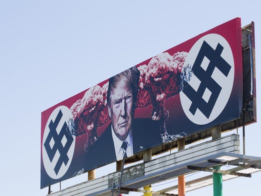 A billboard depicting President Donald Trump flanked