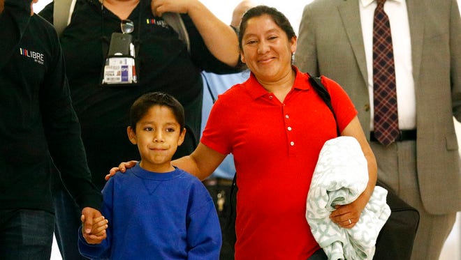 Darwin Micheal Mejia, 7, and his mother, Beata Mariana de Jesus Mejia-Mejia, are escorted to a news conference after their reunion at Baltimore-Washington International Thurgood Marshall Airport, June 22, 2018, in Linthicum, Maryland. The Justice Department agreed to release Mejia-Mejia's son after she sued the U.S. government in order to be reunited following their separation at the U.S. border. She has filed for political asylum in the U.S. following a trek from Guatemala.