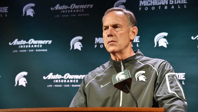 Mark Dantonio listens to a question during Tuesday's press conference in East Lansing.