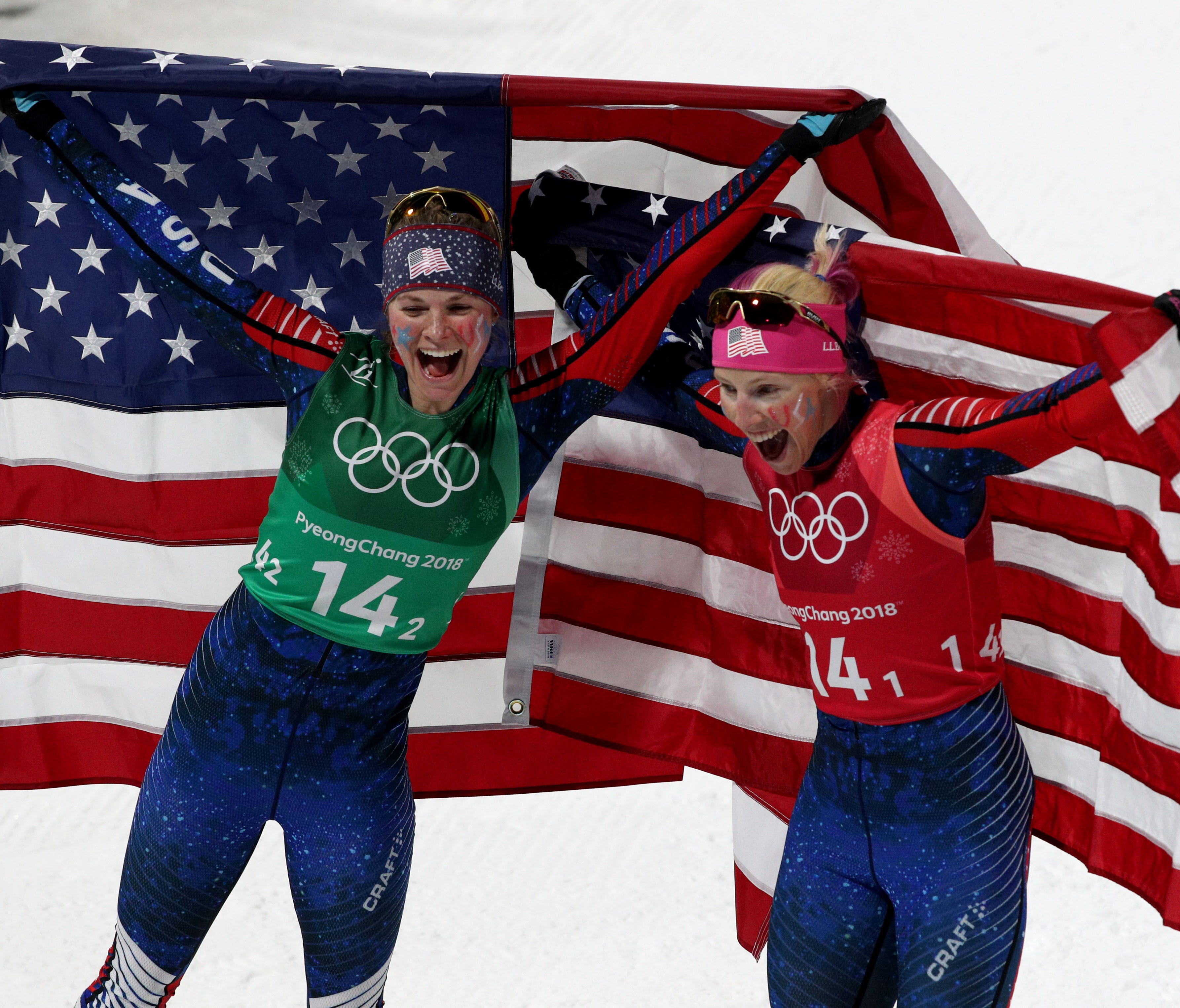 Jessie Diggins (left) and Kikkan Randall  celebrate winning a historic gold medal in the women's cross-country skiing team sprint freestyle final during the Pyeongchang 2018 Olympic Winter Games at Alpensia Cross-Country Centre on Feb. 21.