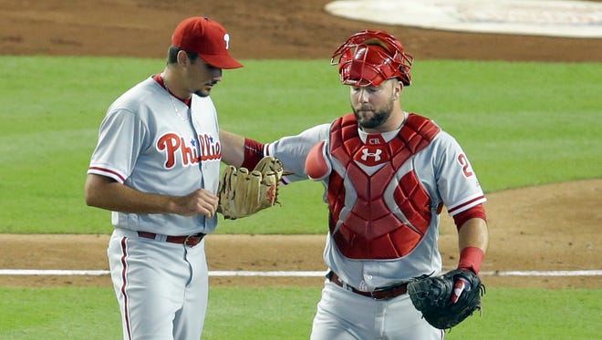 Phillies pitcher Zach Eflin talks with catcher Cameron Rupp during the first inning Wednesday. The Marlins scored three runs in the frame.