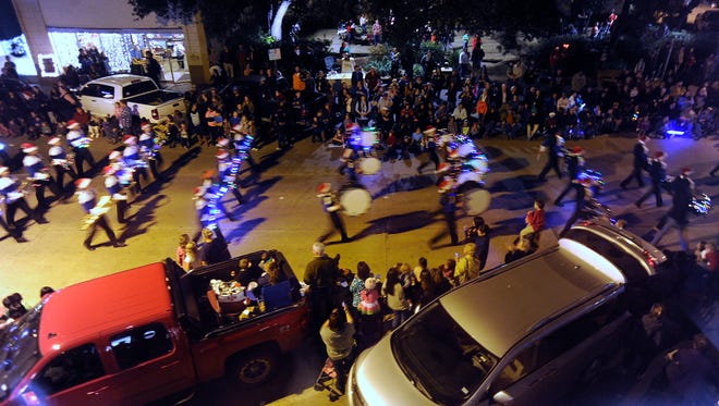The Cooper High School band marches down Cypress Street on Tuesday during the City Sidewalks parade in downtown Abilene. An estimated 12,000 people gathered to view the parade.