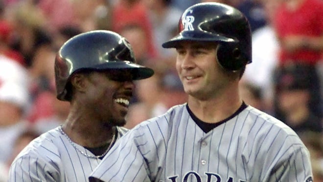Colorado Rockies' Jeffrey Hammonds, left, and Scott Servais, right, celebrate after scoring on a base hit by pitcher Rolando Arrojo in the fourth inning against the Cincinnati Reds in Cincinnati. The Seattle Mariners have hired former major league catcher Scott Servais as their manager. New Mariners general manager Jerry Dipoto made the announcement Friday, Oct. 23, 2015. Servais replaces Lloyd McClendon, who was let go earlier this month.