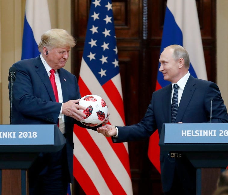 Vladimir Putin gives Donald Trump a soccer ball from the 2018 FIFA World Cup, Helsinki, Finland, 16 July 2018.
