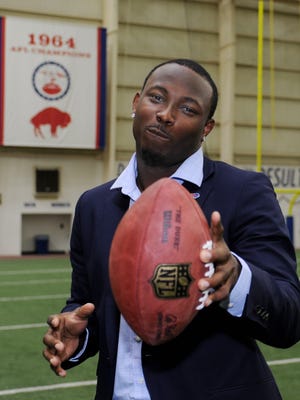 Buffalo Bills running back LeSean McCoy gestures with a football while being introduced at a news conference in Orchard Park March 10, 2015.