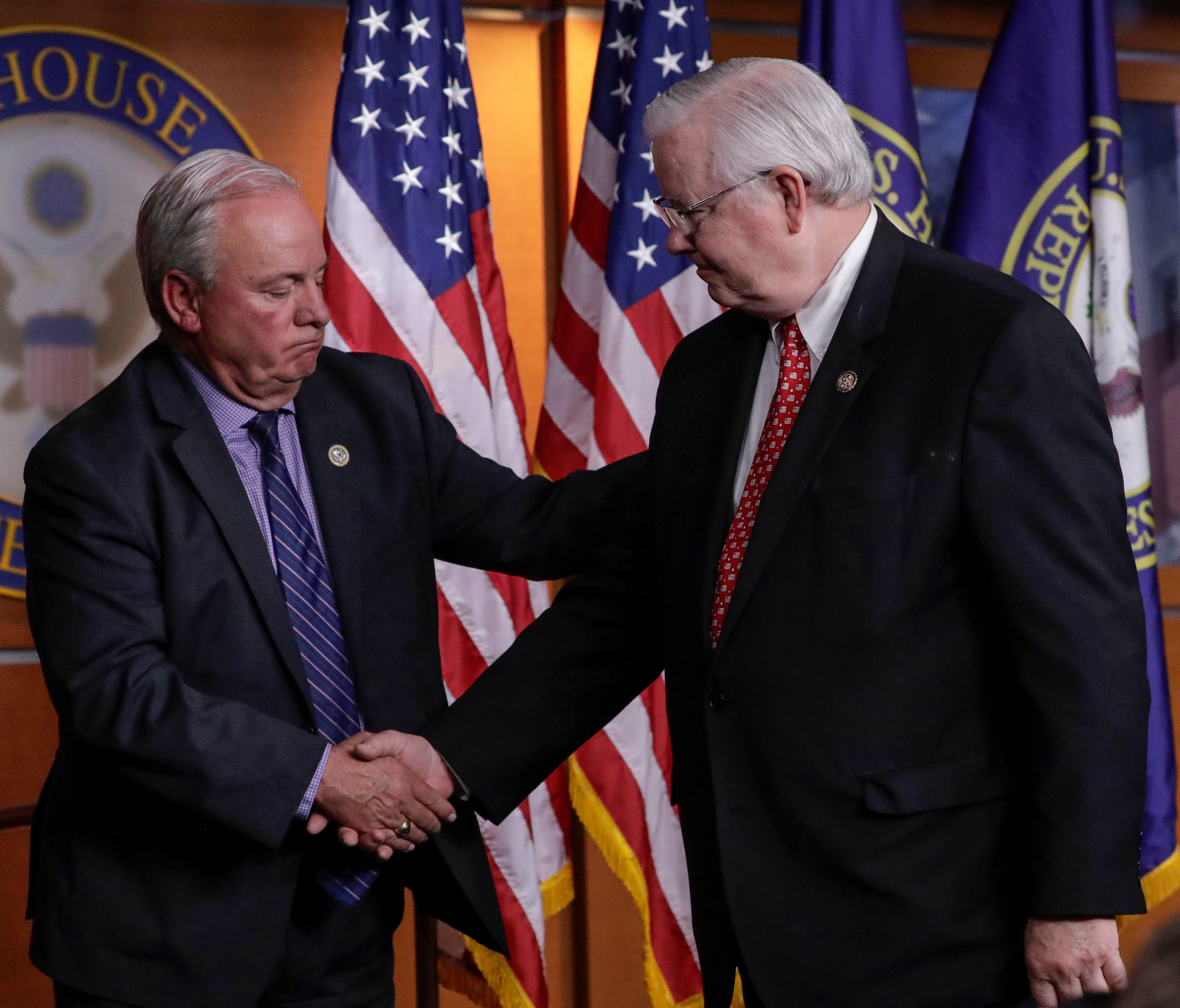 Rep. Mike Doyle, D-Pa., (left) and Rep. Joe Barton, R-Texas, (right) managers of the congressional baseball teams, shake hands during a news conference on Capitol Hill. Both men talked about the shooting during a congressional baseball practice in Al