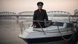 Sailor Kim Il-Soo poses for a photo on a boat used
