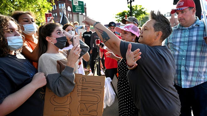 President Trump supporter Jessie Morgan of Nashua, New Hampshire, right, has a heated exchange with Keilah Lopes, 17, of Natick and other Natick teenagers as Trump supporters and a group of primarily teenage counter protesters squared off Saturday afternoon on Natick Common.   Earlier police  arrested one man during a dispute between Trump supporters and counter protesters, a melee that brought in support from Framingham and Sherborn police.