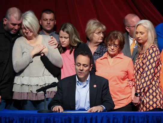 Kentucky Gov. Matt Bevin, center, offers a statement of support for the victims of the Marshall County High School shooting as family members became emotional behind him. They were at the Children’s Arts Center in Benton, Ky., on Jan. 26, 2018.