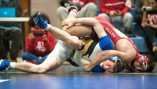 Rancocas Valley's Drew Bowker, top, controls Williamstown's Nick Cope during the 182 lb. bout of Monday's South Jersey Group 5 first round playoff wrestling match held at Williamstown High School.  Bowker won, 12-3.  
