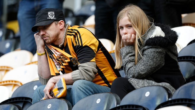 Hull City fans look on dejected after the club's relegation was confirmed.
