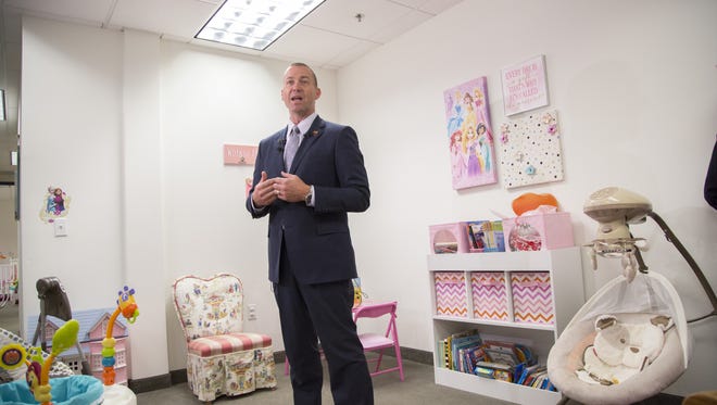 Greg McKay, director of the Arizona Department of Child Safety, speaks to the press during a tour of a new children's emergency placement center in Phoenix on Sunday, May 31, 2015.