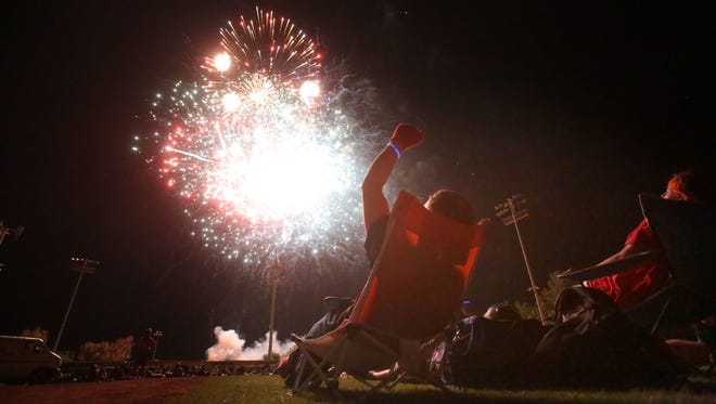 Spectators watch the 4th of July fireworks display at the Palm Springs Stadium on Saturday. 