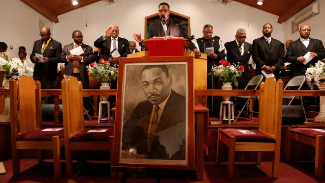 Rev. Weldon McWilliams IV leads an opening prayer at the 42nd annual Dr. Martin Luther King Jr. Service at the First Baptist Church in Spring Valley on Jan. 17, 2016.  