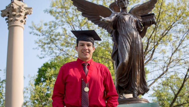 Anthony Marquez, a former marine, sits among hundreds of empty chairs on the the Arts Terrace at Ball State University where he will graduate with a 3.96 on Saturday. Marquez was not a great student in high school, but turned that around in the marine core.