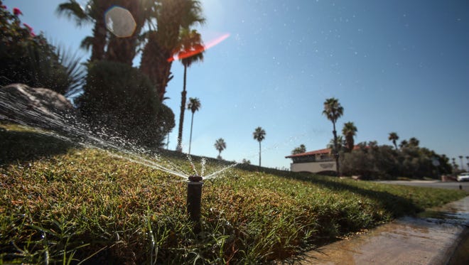 Sprinklers water the grass at the Renaissance Palm Springs on June 23, 2016.