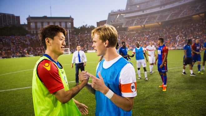 Crystal Palace's Chung-Yong Lee and FC Cincinnati's Jimmy McLaughlin shake hands at the end of the friendly match at Nippert Stadium on Saturday. Crystal Palace won 2-0.