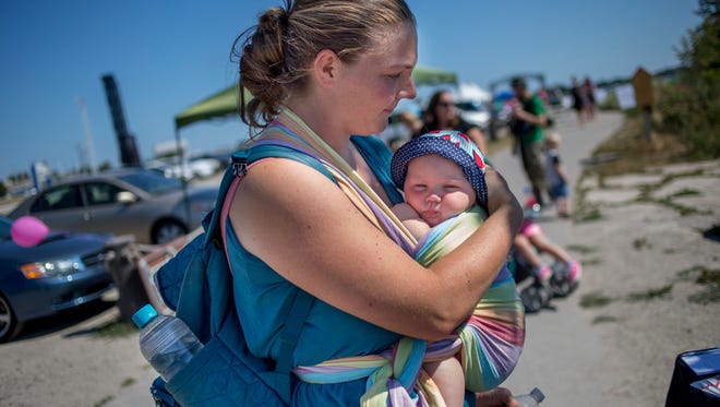 Lacie Hollenbeck, of Marysville, holds her 5-month-old daughter Myrah during a Breastfeeding Stroll hosted by the St. Clair County Health Department Tuesday, August 2, 2016 along the Blue Water River Walk in Port Huron.