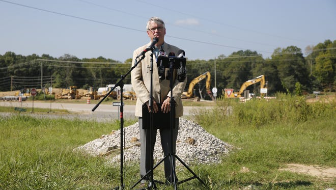 Bloomington Mayor John Hamilton discusses the impact of I-69 construction delays during a press conference near Sample Road and Ind. 37, Wednesday, Sept. 7, 2016, in Bloomington, Ind. Hamilton asked Indiana Gov. Mike Pence, who is running for Vice President of the United States with Donald Trump, to intervene so construction can continue before winter. Sub-contractor Crider & Crider Inc. has stopped work on the highway due to non payment the overall contractor for section 5 of the project. Section 5 stretches from Bloomington, Ind., to Martinsville, Ind.  (Jeremy Hogan/Bloomington Herald-Times via AP)