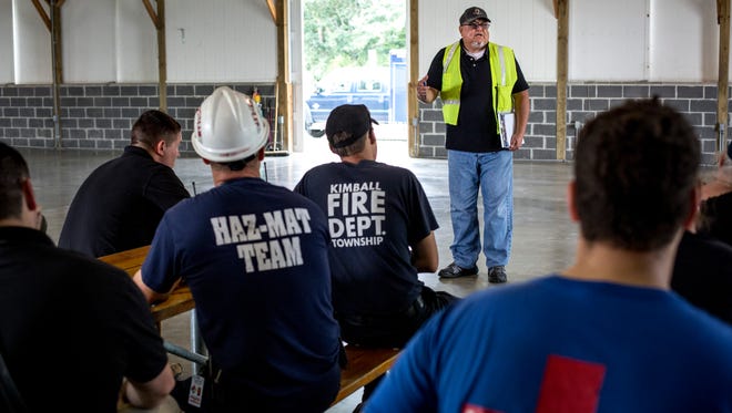 Tony Garcia, a program manager with the Michigan State Police, speaks with participants after a hazardous materials drill Wednesday, September 21, 2016 at Goodells County Park.