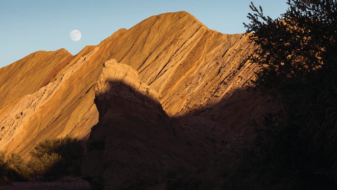Many Eastern Coachella Valley residents who go away to college and return to help improve their communities say they are inspired by the natural beauty that surrounded them growing up. Above, a full moon rising over Box Canyon in Mecca.