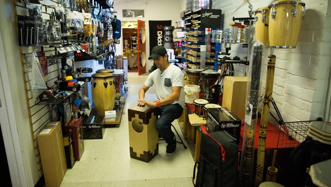 Mike Trujillo, assistant percussion manager at Hubbard's music, demonstrates how to play a Monk Drum. These hand made drums are built locally in Chaparral and are available at Hubbard's.