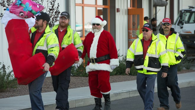 Carrying large stockings filled with toys into the Border International Trucking building, Brian Kleine, from left, Christopher Kleine, Clyde Williamson dressed as Santa Claus, Don Kleine and Matt Ford, all from Kleine Towing, participate in the Truckers Toy Drive. The group of truck drivers was among many that gathered Saturday December 17, 2016 to load toys up into their trailers. The toys will be distributed at area hospitals.