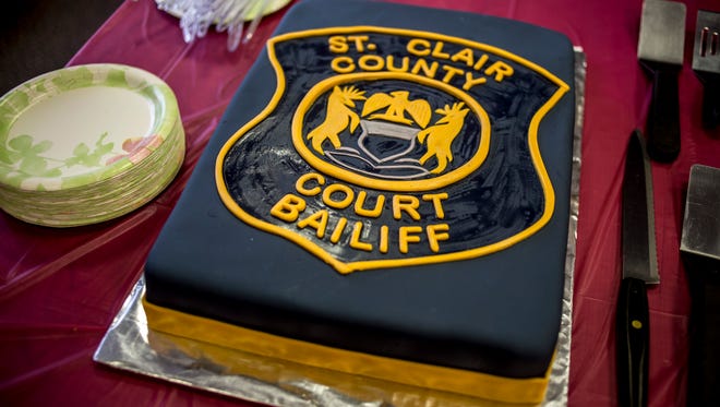 A cake is designed as a Court Bailiff badge during a retirement party for Charlie Collins Friday, Jan. 27, 2017 at the St. Clair County Courthouse.