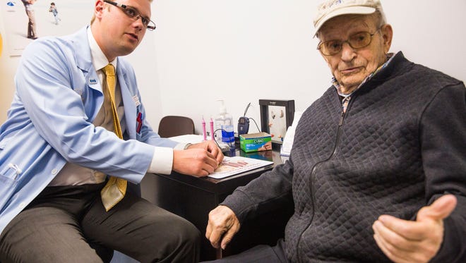 Audioprosthologist Donald Kleindl III helps Harry Friedman, 99, of Marco Island with his hearing aids from Life Hearing & Tinnitus Health Centers on Marco Island on Wednesday, March 15, 2017.