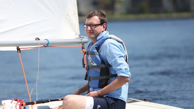 Captain Tad Mast stares off into the far horizon on the small Laser sailboat.