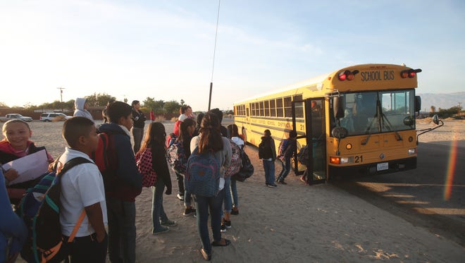 Children in Coachella Valley Unified School District line up to catch a school bus in North Shore in this Desert Sun file photo taken in December 2016.