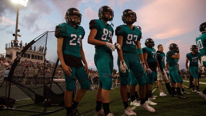 Gulf Coast High School football team members watch from the sidelines at Golden Gate High School in Naples where the Sharks took on the Riverdale Raiders on Thursday, September 28, 2017.
