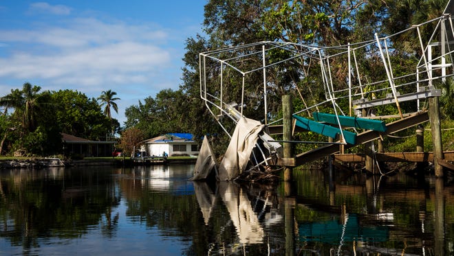 A boat dock canopy, destroyed by Hurricane Irma, sits in the Imperial River in Bonita Springs on Thursday, Oct. 12, 2017. 